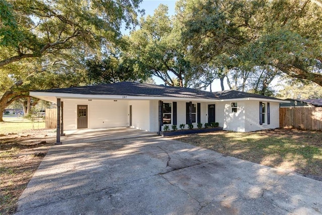 297 Nassau Dr, Slidell, LA 70458 - ranch-style house with fence, an attached carport, brick siding, and concrete driveway