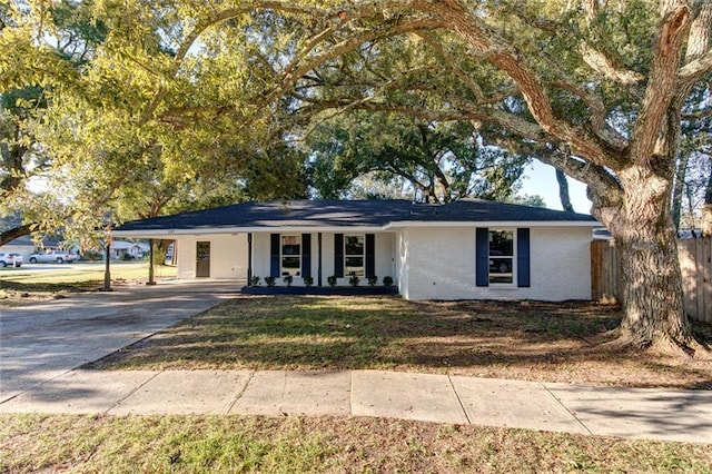 297 Nassau Dr, Slidell, LA 70458 - ranch-style home with a carport, a porch, concrete driveway, brick siding, and a front yard