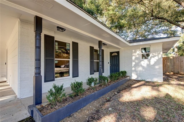 view of exterior entry with covered porch