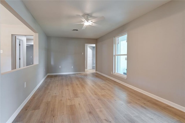 empty room with light wood-type flooring and ceiling fan