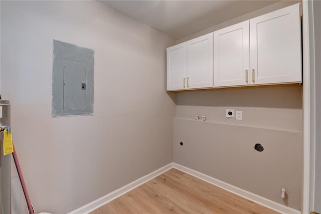 washroom with cabinets, electric panel, light hardwood / wood-style flooring, hookup for a gas dryer, and hookup for an electric dryer