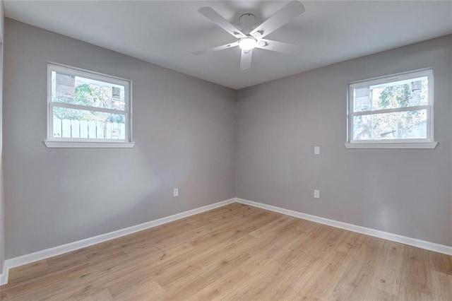 spare room featuring light wood-type flooring and ceiling fan