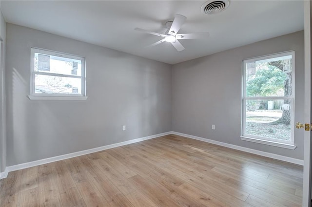 empty room with ceiling fan and light wood-type flooring