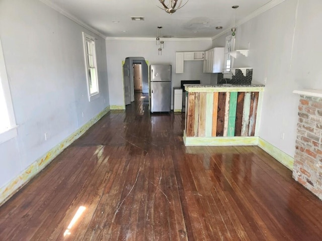 kitchen with white cabinetry, crown molding, stainless steel fridge, and dark hardwood / wood-style flooring