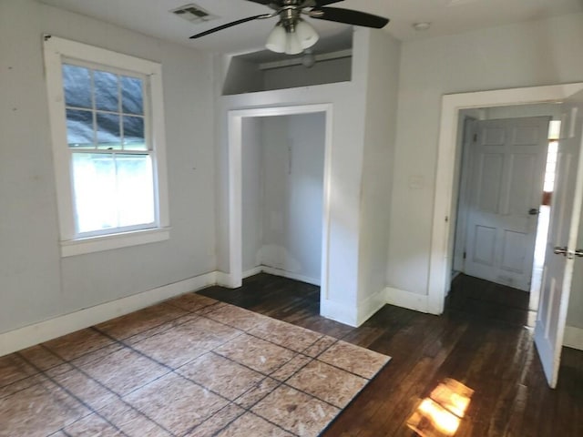 unfurnished bedroom with dark hardwood / wood-style flooring, a closet, and ceiling fan