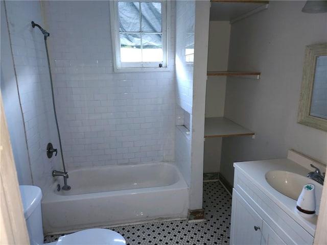 full bathroom with toilet, tiled shower / bath combo, vanity, and tile patterned floors