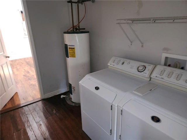 clothes washing area with independent washer and dryer, water heater, and dark hardwood / wood-style flooring