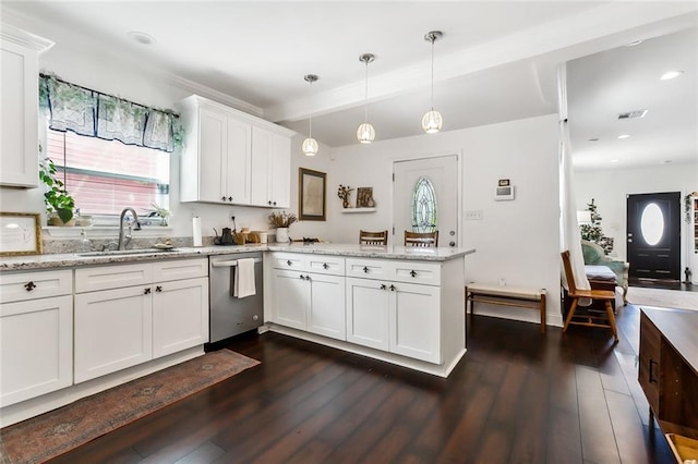 kitchen with sink, stainless steel dishwasher, white cabinets, and decorative light fixtures