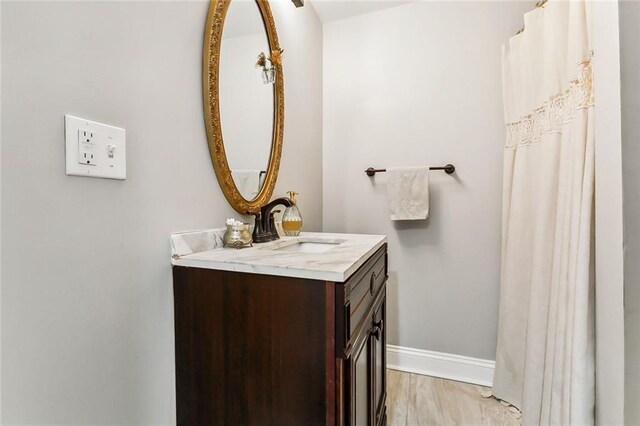 bathroom featuring vanity and wood-type flooring