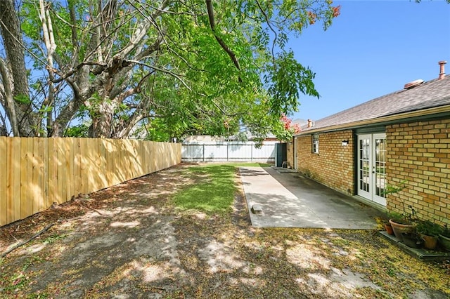 view of yard featuring french doors and a patio