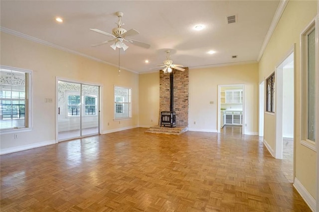 unfurnished living room with a wood stove, ornamental molding, light parquet flooring, and ceiling fan