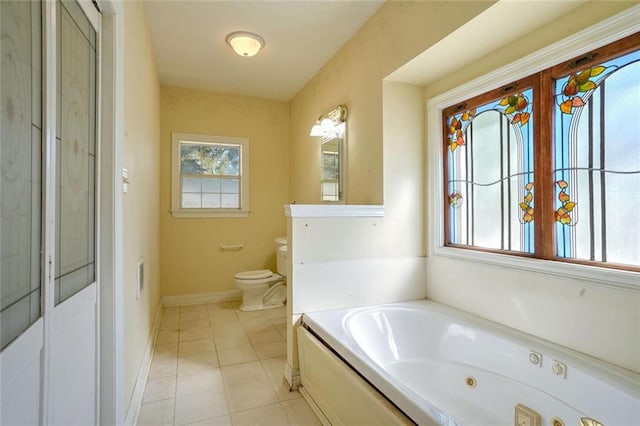 bathroom featuring a bath, toilet, and tile patterned floors