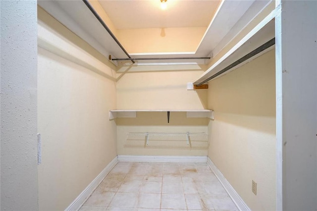 spacious closet with light tile patterned floors