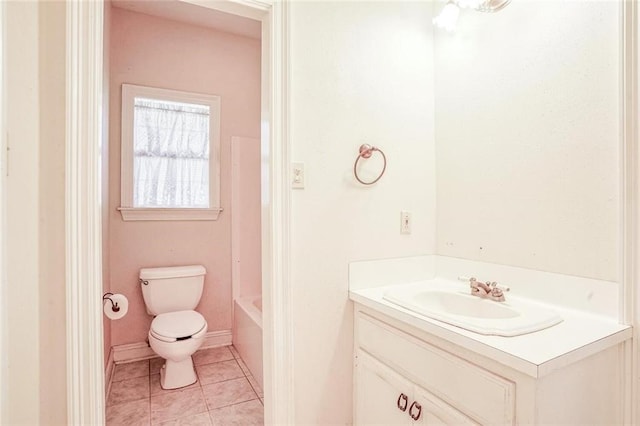 bathroom featuring vanity, toilet, tile patterned floors, and a tub