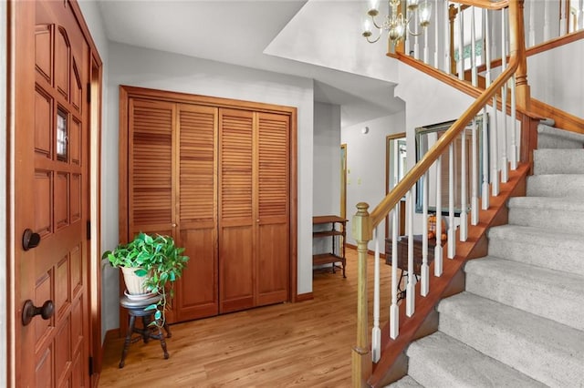 entryway with a chandelier and light hardwood / wood-style flooring