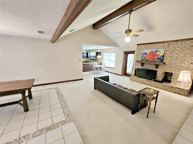 tiled living room featuring lofted ceiling with beams, a fireplace, a textured ceiling, and ceiling fan