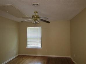 unfurnished room featuring ceiling fan and dark hardwood / wood-style flooring