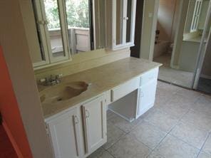 bathroom featuring vanity, toilet, and tile patterned floors