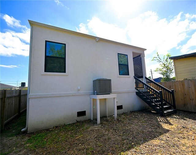 rear view of property featuring central AC unit