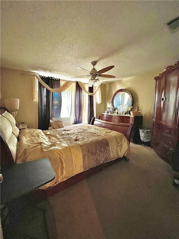 bedroom with carpet, ceiling fan, and a textured ceiling