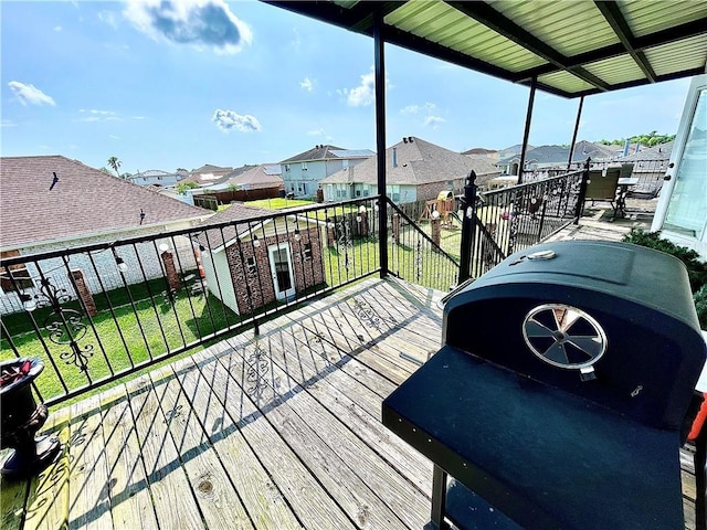 wooden terrace featuring a yard