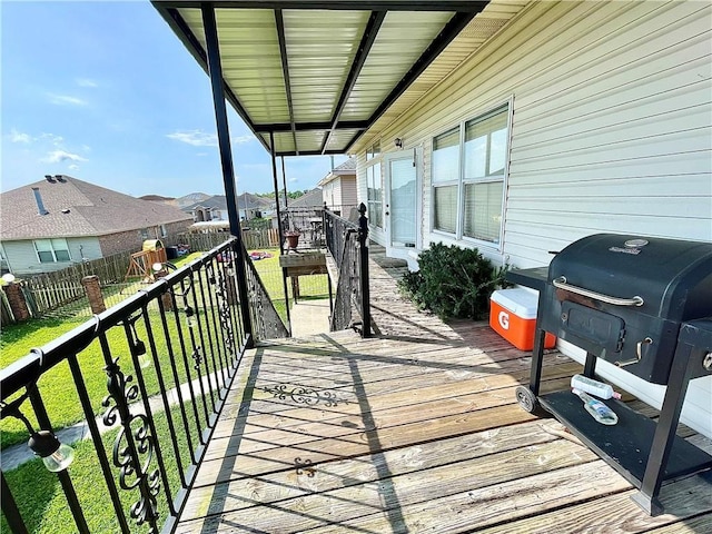 wooden deck featuring a lawn