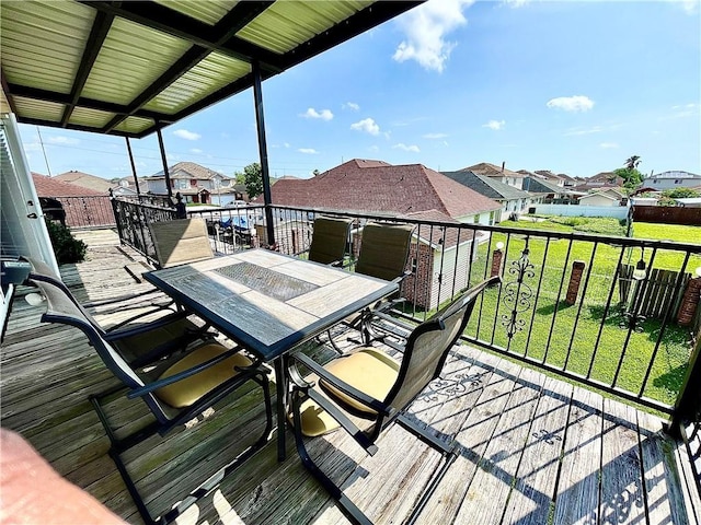 wooden deck featuring a lawn