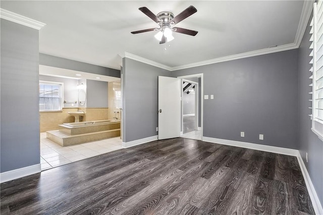 unfurnished room featuring ceiling fan, wood-type flooring, and ornamental molding