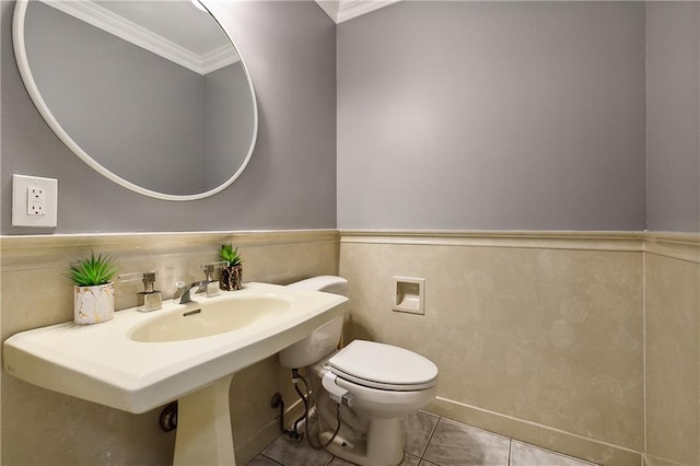 bathroom featuring toilet, tile patterned floors, and ornamental molding