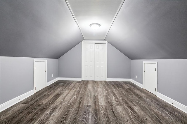 bonus room featuring lofted ceiling and dark wood-type flooring