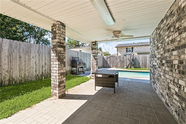 view of patio / terrace featuring area for grilling, ceiling fan, and a fenced in pool