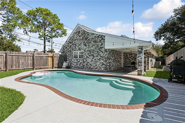 view of swimming pool with a patio and central air condition unit