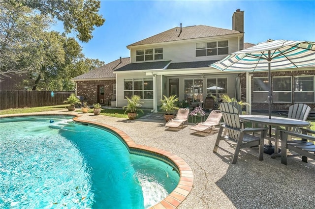view of pool with a fenced in pool, a patio area, and fence