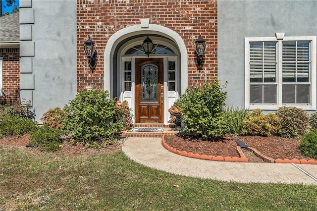 property entrance with brick siding