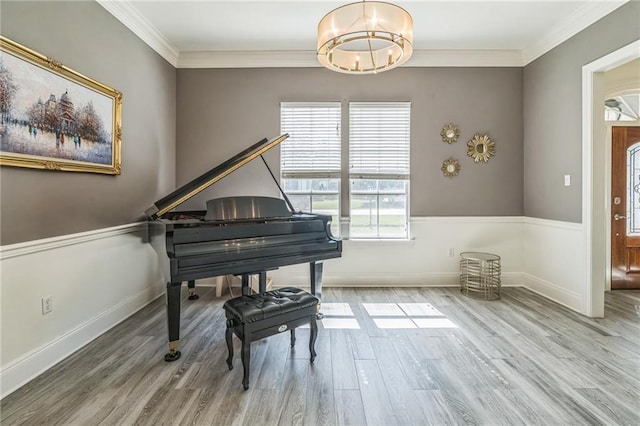 miscellaneous room with a chandelier, crown molding, and hardwood / wood-style flooring