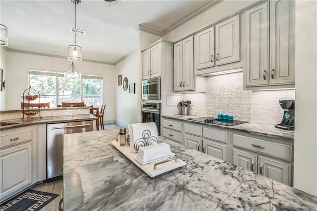 kitchen with decorative light fixtures, light stone countertops, stainless steel appliances, and gray cabinetry