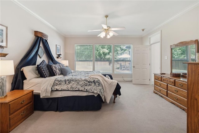 carpeted bedroom featuring ceiling fan and crown molding