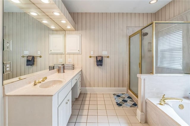 full bathroom with a garden tub, tile patterned flooring, a shower stall, vanity, and baseboards