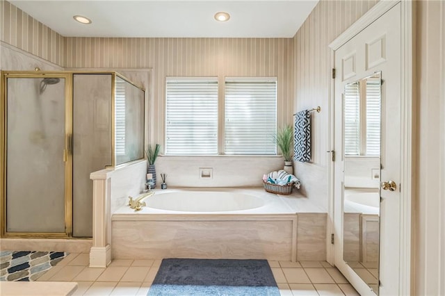 full bathroom with tile patterned flooring, plenty of natural light, a shower stall, and a garden tub