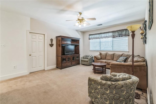 carpeted living area featuring baseboards, a ceiling fan, and visible vents