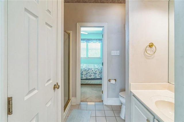 ensuite bathroom featuring tile patterned flooring, vanity, toilet, baseboards, and a stall shower