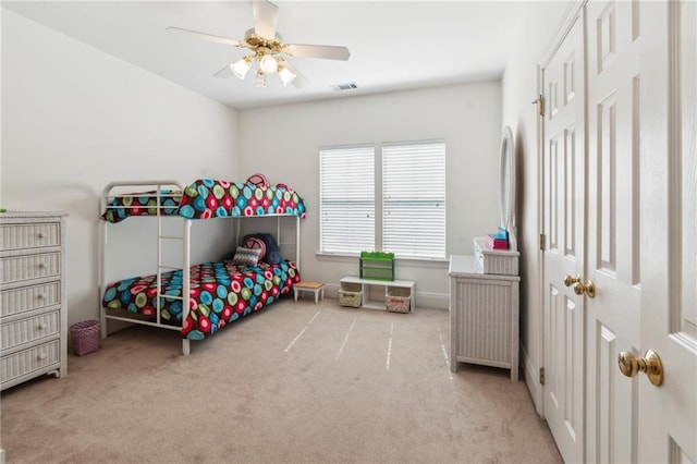bedroom with visible vents, a ceiling fan, and carpet