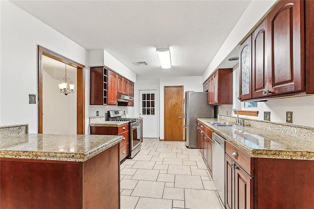 kitchen featuring appliances with stainless steel finishes, a textured ceiling, sink, light tile patterned floors, and a chandelier