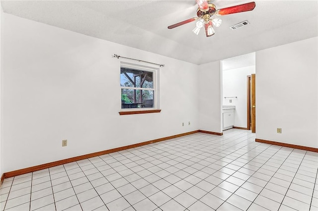 unfurnished room featuring ceiling fan and light tile patterned floors