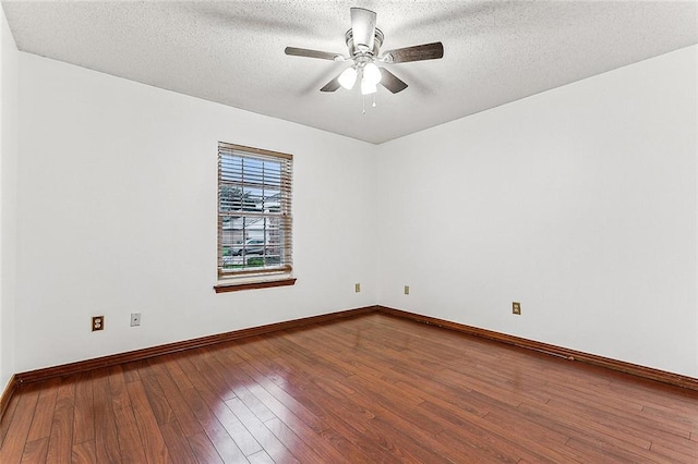 spare room featuring ceiling fan, wood-type flooring, and a textured ceiling