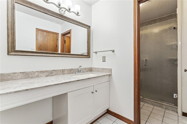 bathroom featuring tile patterned floors, vanity, and an enclosed shower