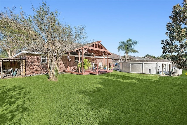 view of yard with a swimming pool side deck