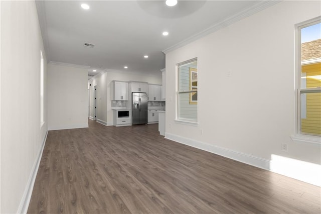 unfurnished living room featuring ornamental molding, dark wood-type flooring, and ceiling fan