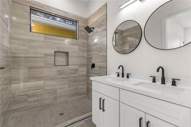 bathroom featuring vanity and tiled shower