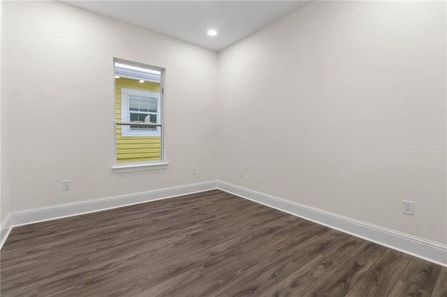 spare room featuring dark hardwood / wood-style floors